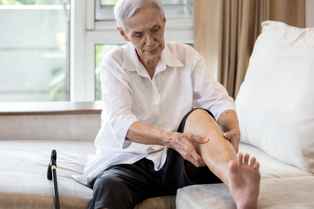 woman rubbing numb leg