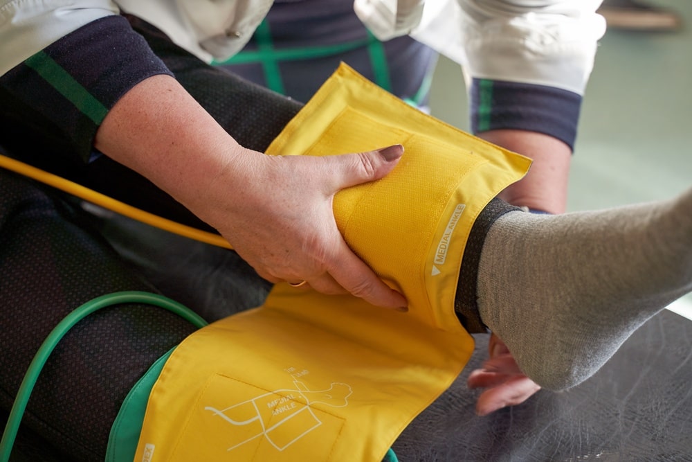Blood pressure check on a person wearing compression socks